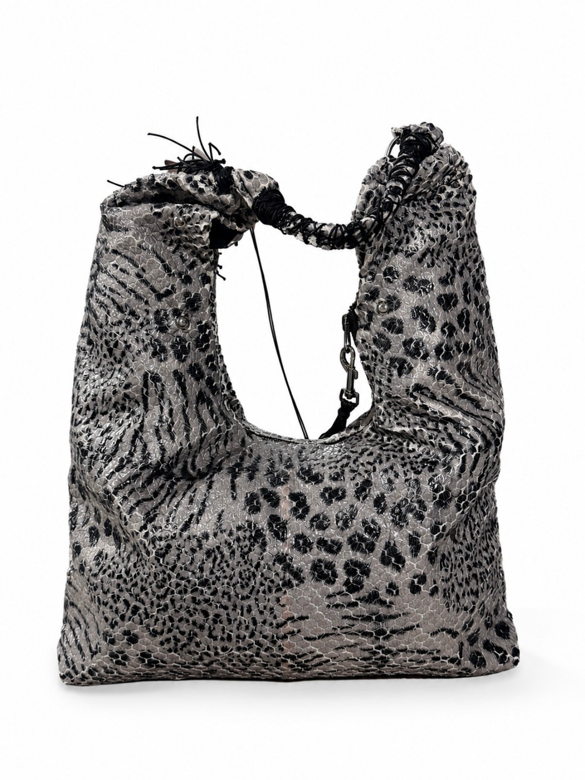 A slouchy shoulder bag with a black and gray leopard print pattern, featuring a drawstring closure at the top and a chain detail on the side, shown against a plain white background.